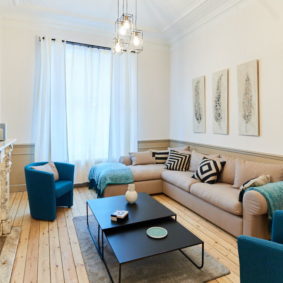 living room including a nice marble fireplace and a large sofa in a flatshare in Etterbeek