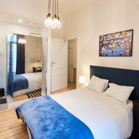 fully decorated ocean style room with comforable double bed and private shower in a coliving space in Brussels