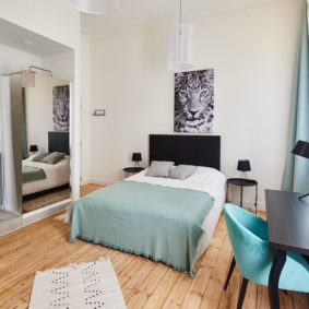 room with double bed including a desk and a private shower in a fully refurbished house for expats in brussels