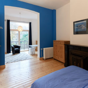 very large room blue style with double bed in a comunity driven house for expats