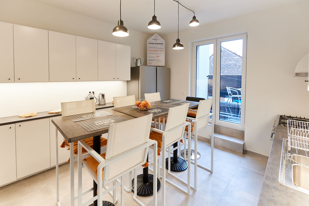 fully equipped kitchen with a design dining table in a fully refurbished house for expats in Brussels