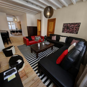 comfortable living room with quality sofas in a fully refurbished shared house in Brussels