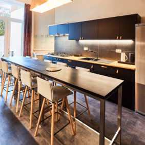 fully equipped kitchen with a design dining table in a fully refurbished house for expats close to the European Comission