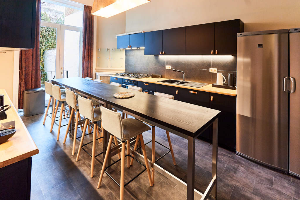 fully equipped kitchen with a design dining table in a fully refurbished house for expats close to the European Comission