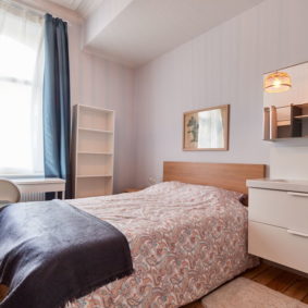 high-end room with a comfortable double bed and a private shower in a shared flat in Brussels