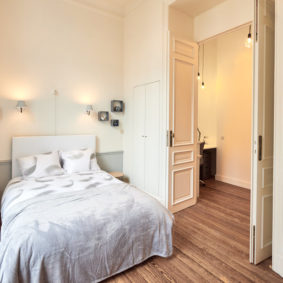 beautifully decorated room with double bed and a private shower in a cohousing for expats in Brussels