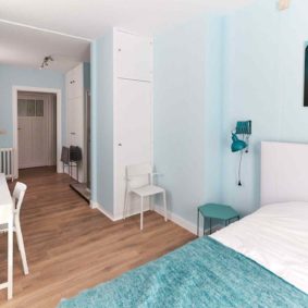 beautifully decoratd room with a double bed and a private shower in a coliving house for expats in Brussels