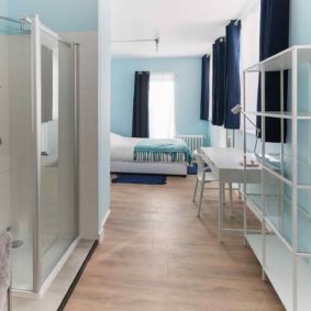 well designed blue style room with comfortable double bed in a sharedd house in Brussels