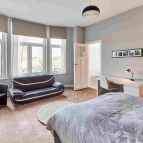 furnished room with a stylish sofa and a private shower in a shared house in Brussels