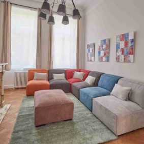 comfortable living room with colourful sofas and comprising a large screen TV with Netflix in a shared house for expats
