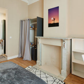 room with a large bed and a private shower in a cohousing in Brussels close to different points of interest