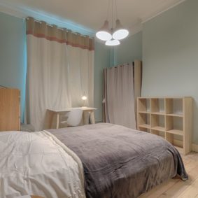 stylish room with a double bed and a private shower in a cohousing space in Brussels