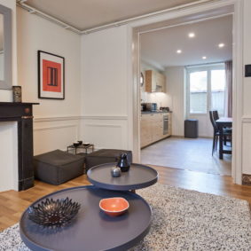 well decorated living room with quality sofas including a large screen TV with netflix in a shared house for expats in Brussels