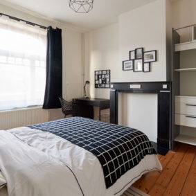 room with a double bed decorated with taste in a shared house for expats in Brussels