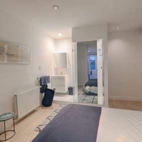 room with a double bed and a private shower in a fully renovated cohabitation house for expats in Brussels