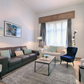 living room decorated with style in a shared house for expats in Brussels including a large screen TV with Netflix