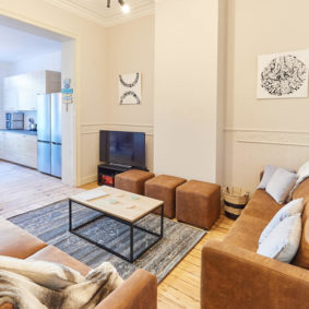 living room decorated with style in a shared house for expats in Brussels including a large screen TV with Netflix