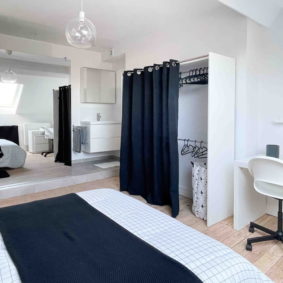 Comfortable double bedroom with desk and chair including a private bathroom to share with community driven young workers in Brussels
