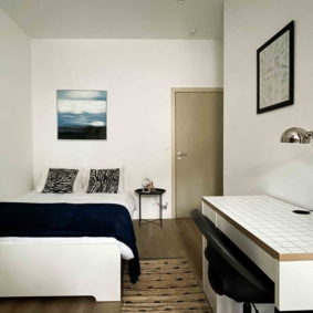 Stylish bedroom with ensuite shower in a coliving house for young international expats